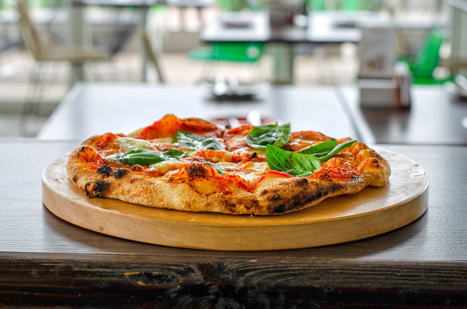 Golden-crust pizza topped with melted cheese and fresh basil